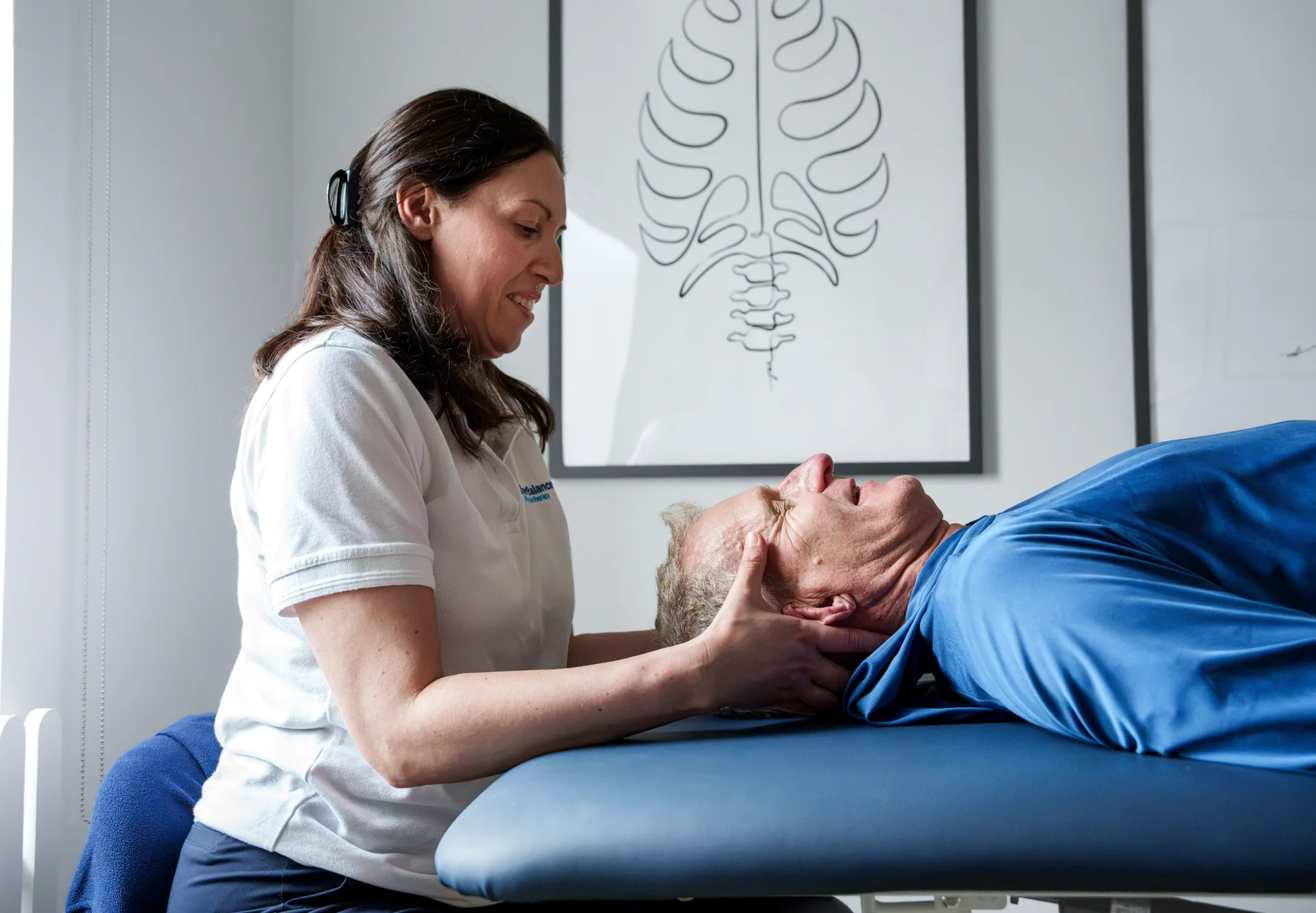 Karen giving gentle hands-on treatment to a patient’s neck