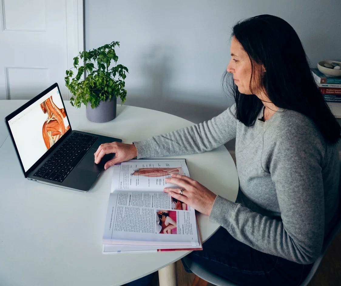 Karen Breslin studying anatomy notes at her laptop